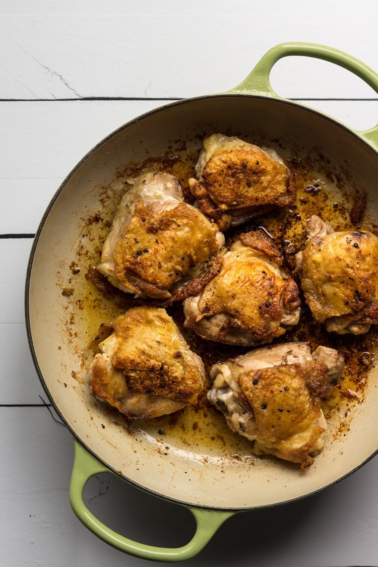 Chicken thighs sauteed in a saute pan