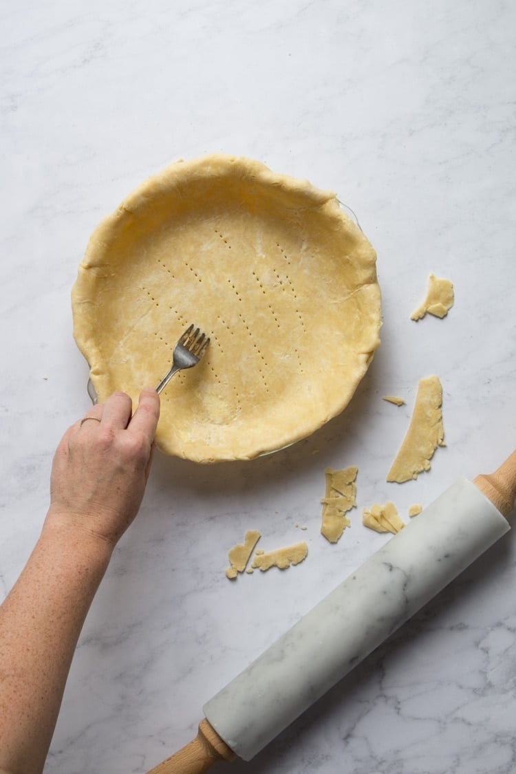 Use a fork to poke holes in pie crust 