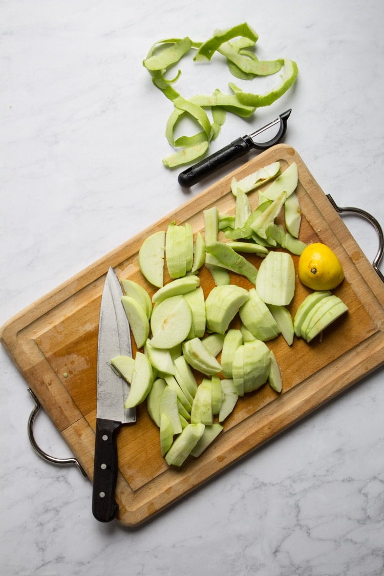 Green apples sliced on a cutting board for apple streusel pie