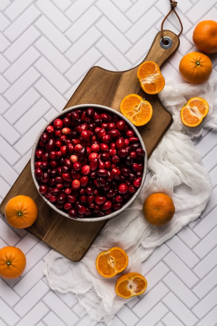 Ingredients for Cranberry Clementine sauce on a wooden board