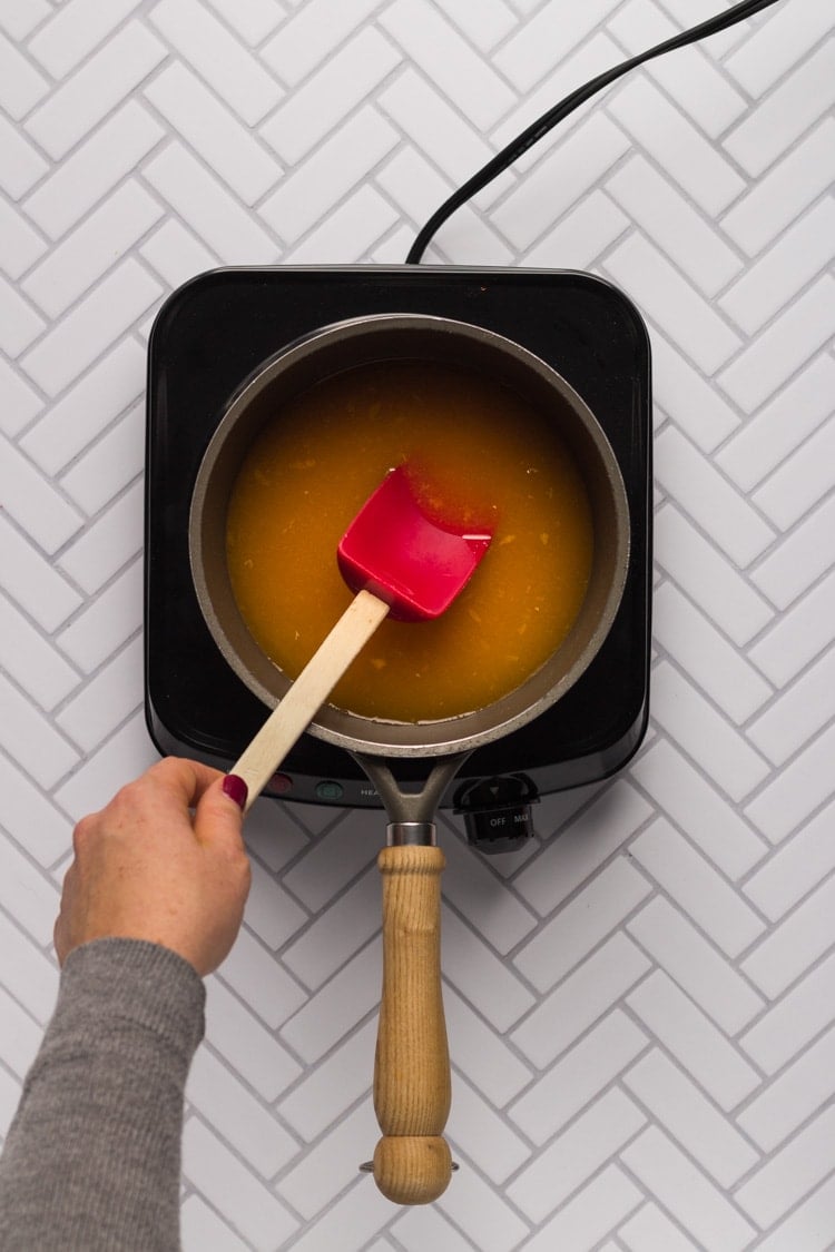 Orange juice in a saucepan for cranberry sauce