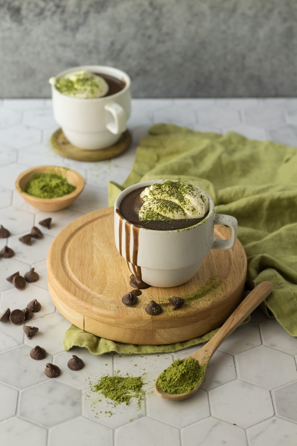 Matcha Hot Chocolate recipe on a wood board with a green napkin