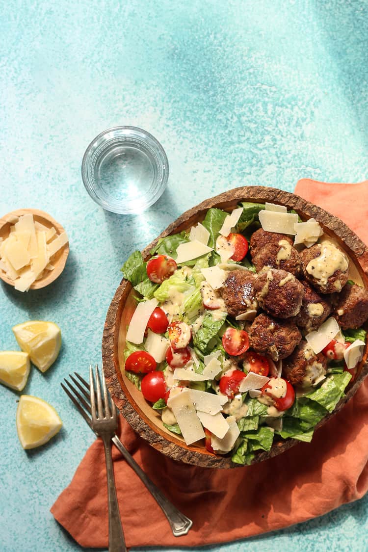 Easy Lamb Meatballs with caesar salad in a wooden bowl