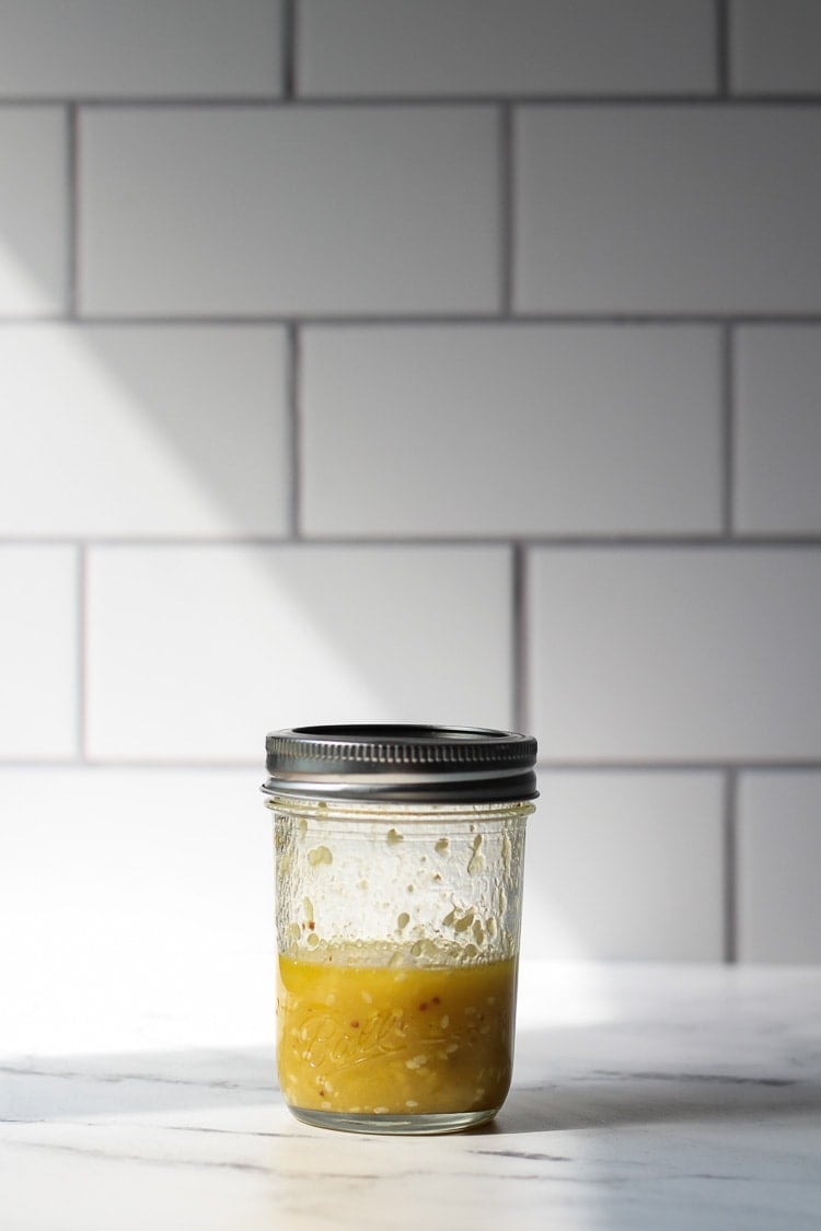 Orange Sesame Vinaigrette for healthy shrimp salad on a countertop