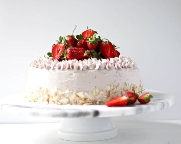 Gluten free strawberry cake on a marble cake stand