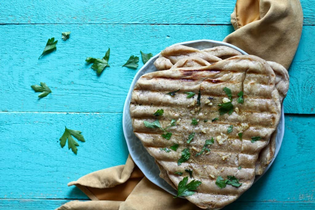 grilled garlic naan bread is so delicious and is a great vessel for many meals