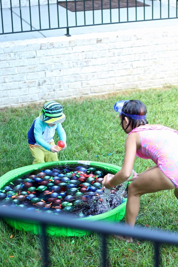 kids playing in water balloon pool