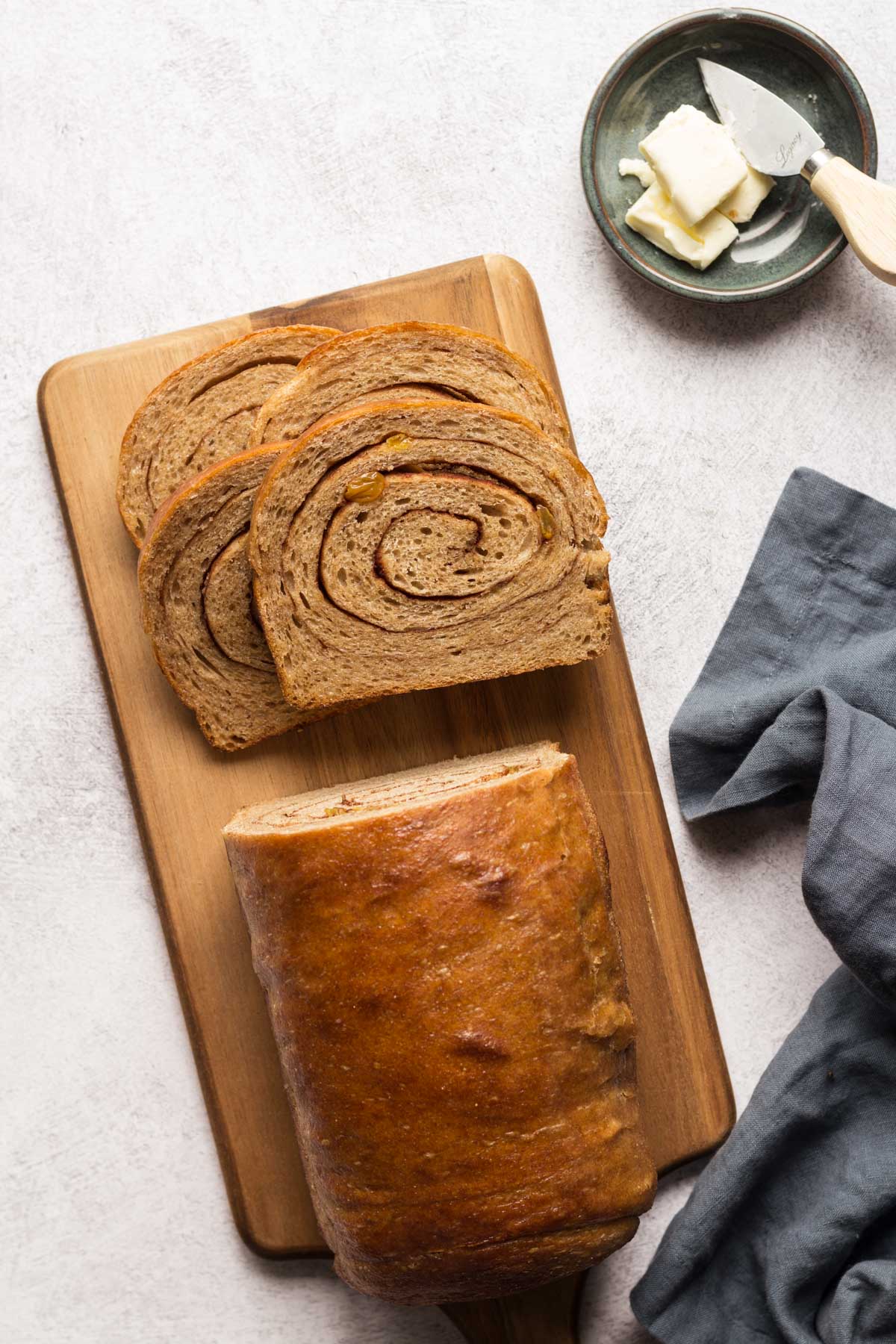 Sliced sourdough cinnamon raisin bread on a cutting board