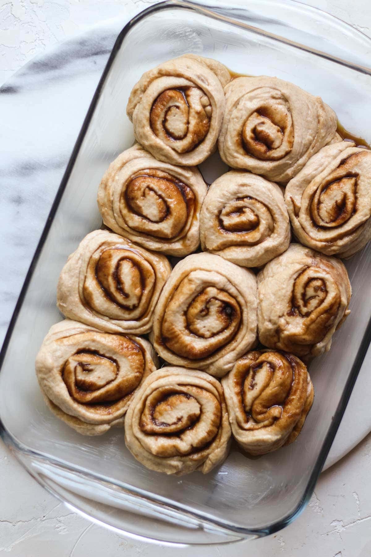 Sourdough cinnamon rolls proofed in a pan