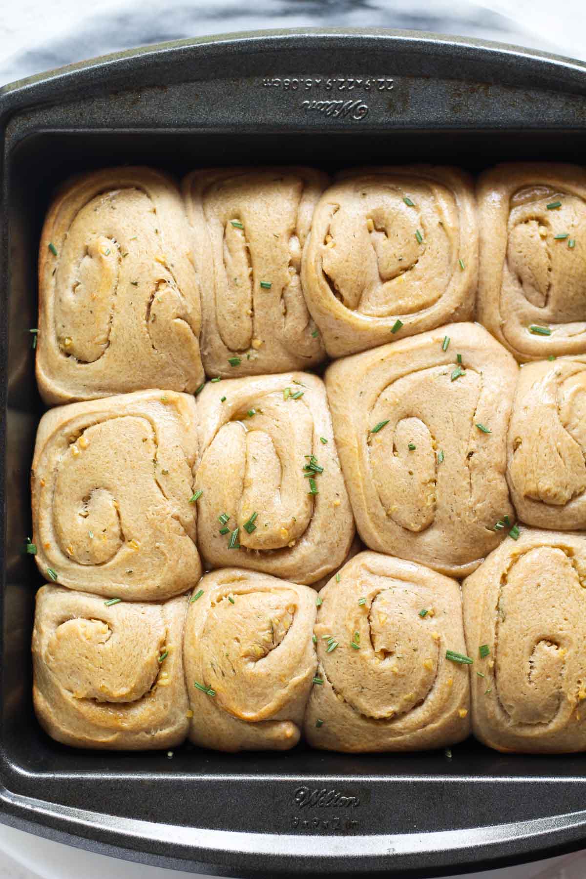 Sourdough garlic rosemary rolls baked in a pan