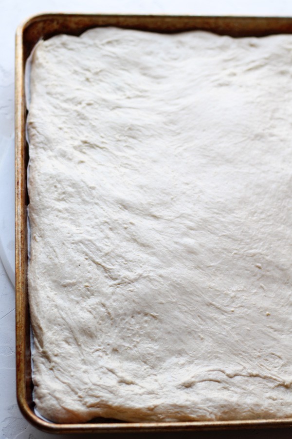 Sourdough Focaccia Dough shaped on a sheet pan