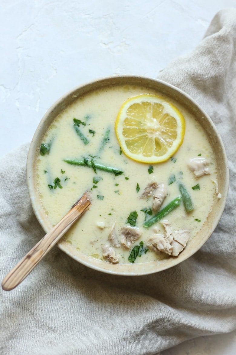 Easy Avgolemono bone broth soup recipe with chicken, cauliflower rice, and green beans in a bowl