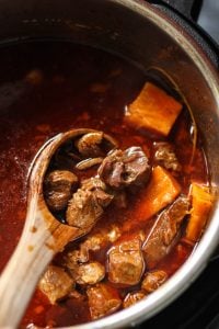 Instant Pot Beef stew recipe with a wooden ladle spoon