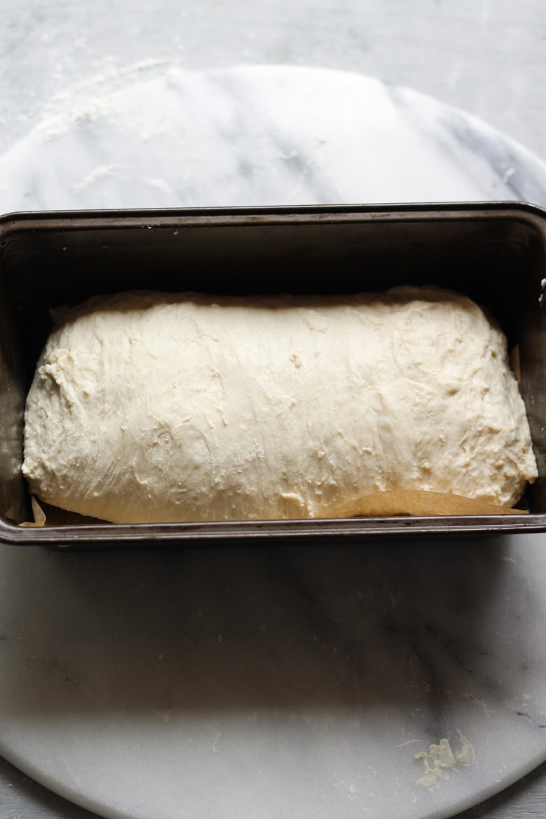 Sourdough bread dough recipe in a loaf tin ready for proofing
