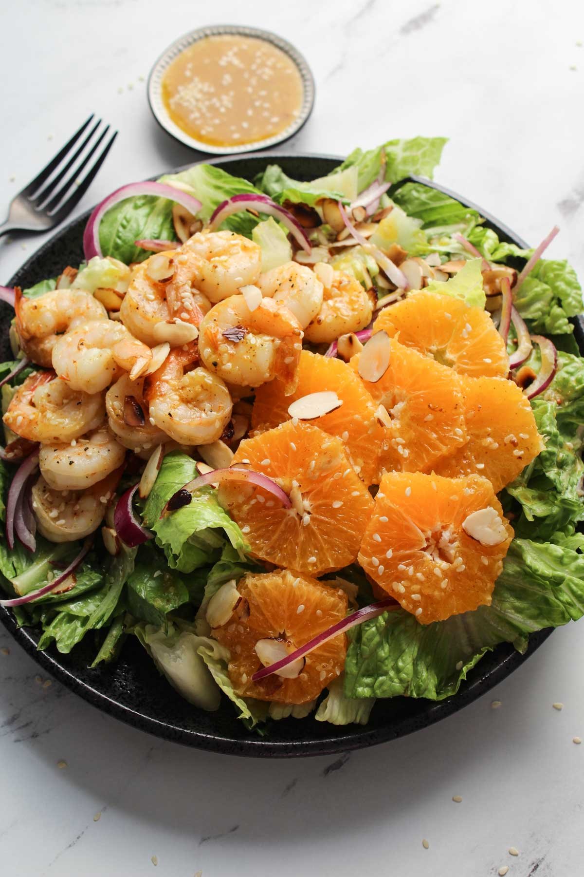 Shrimp salad on a plate with sliced oranges