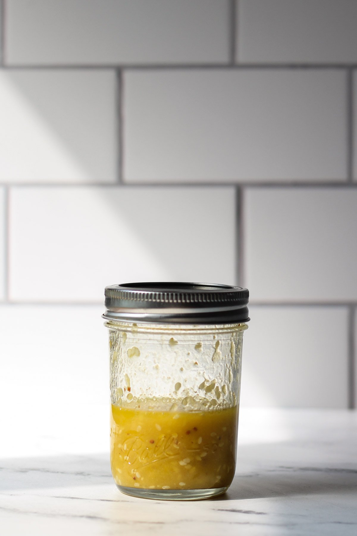 Orange sesame dressing in a mason jar 