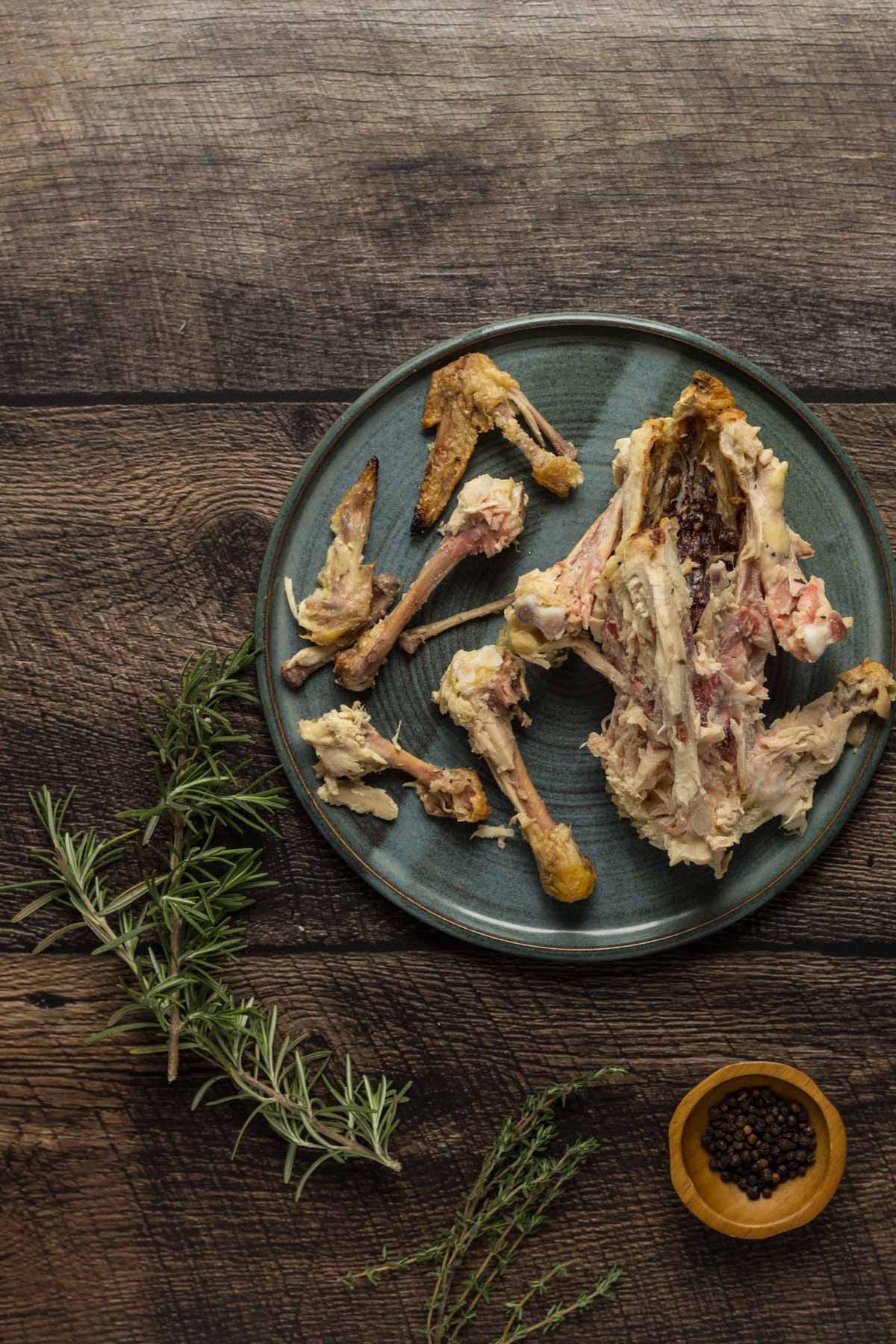 Chicken bones on a plate with rosemary