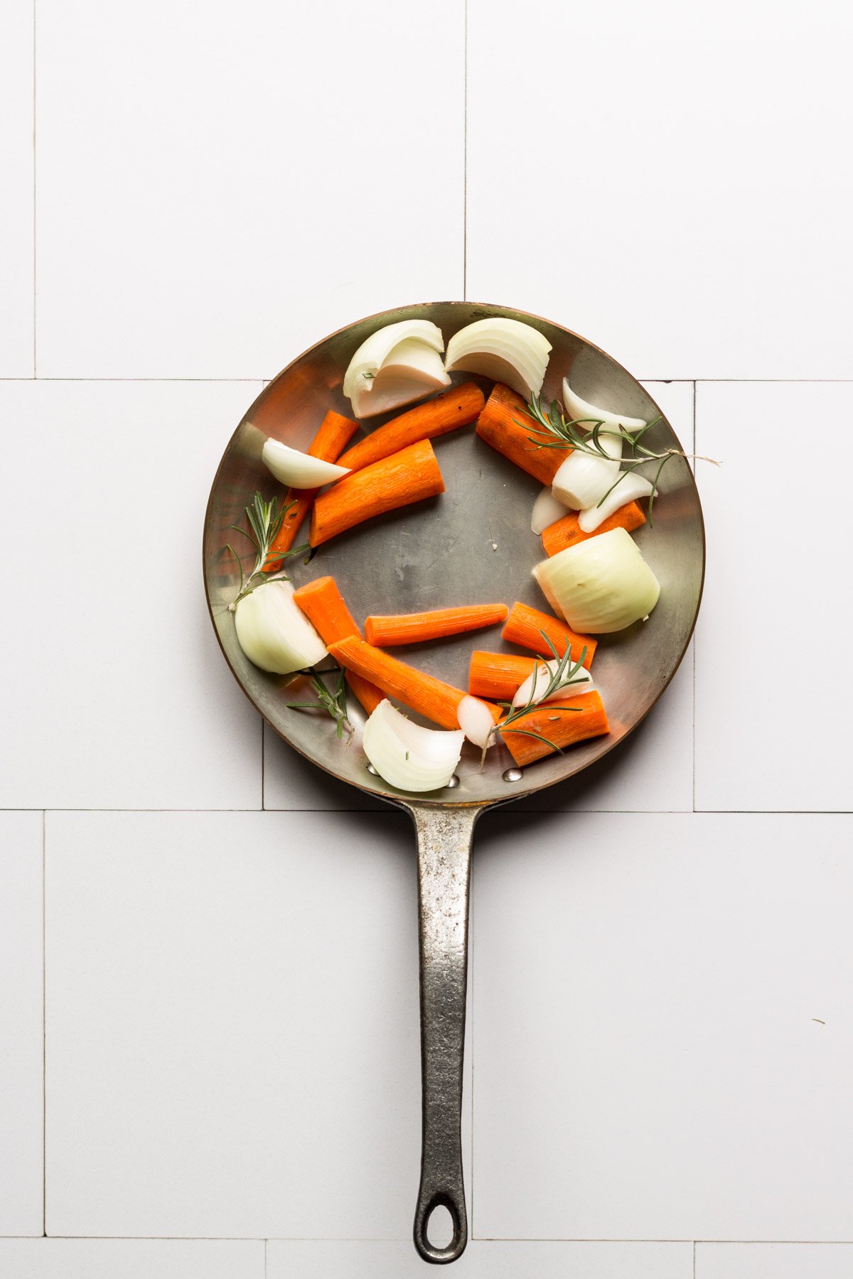 Carrots and onions in a saute pan