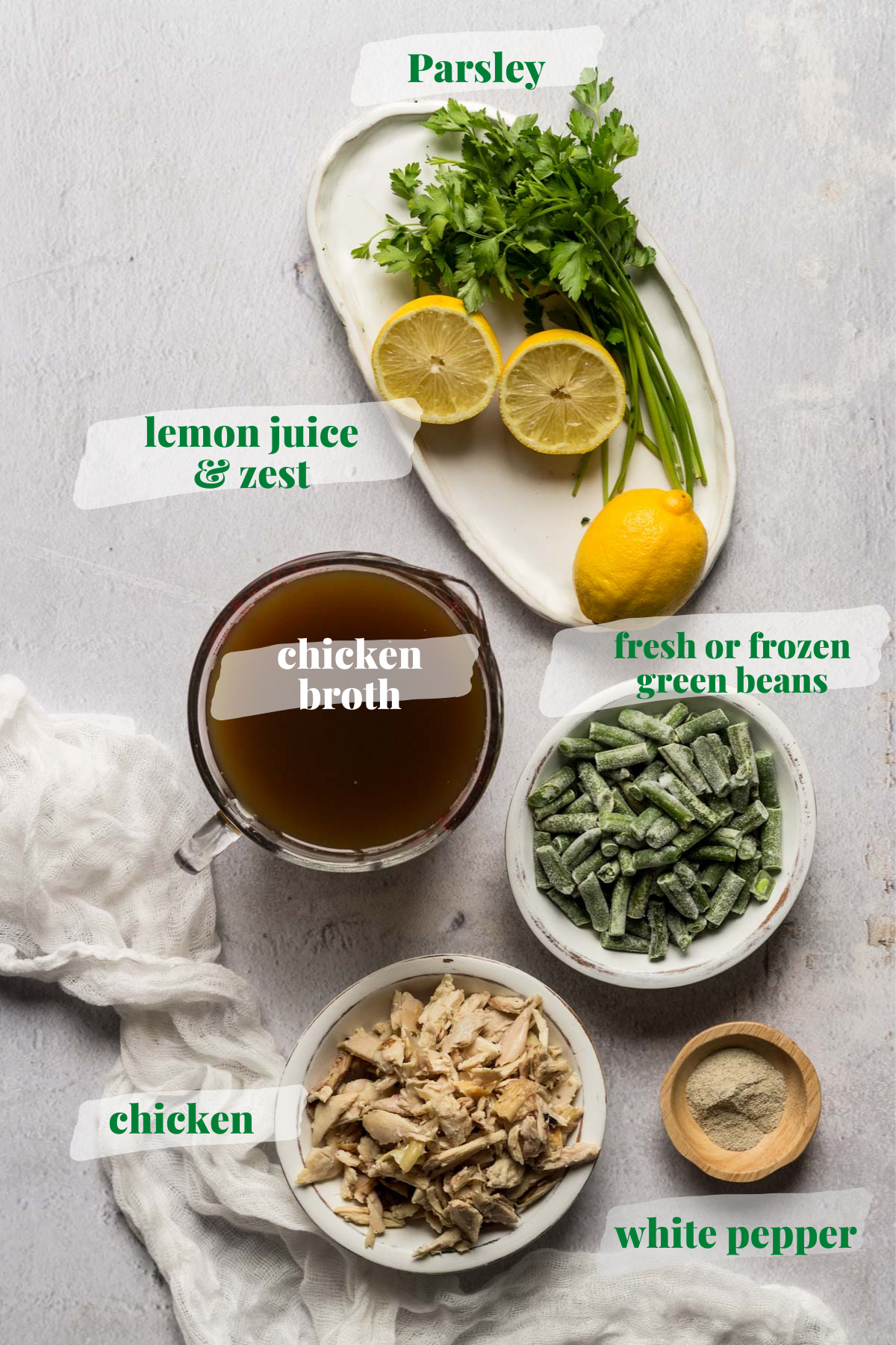 Lemons, parsley, broth, chicken, and green beans in bowls