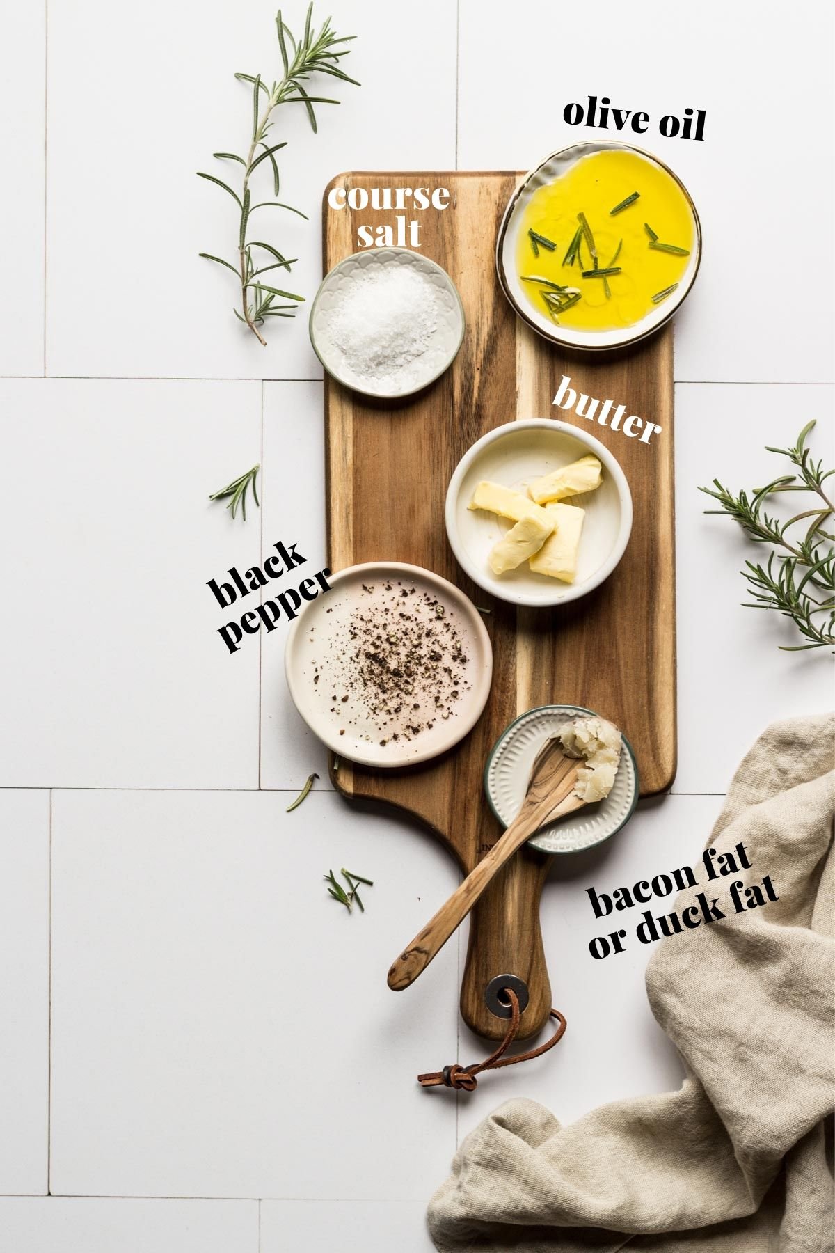 Olive oil, butter, and seasoning on a wooden board