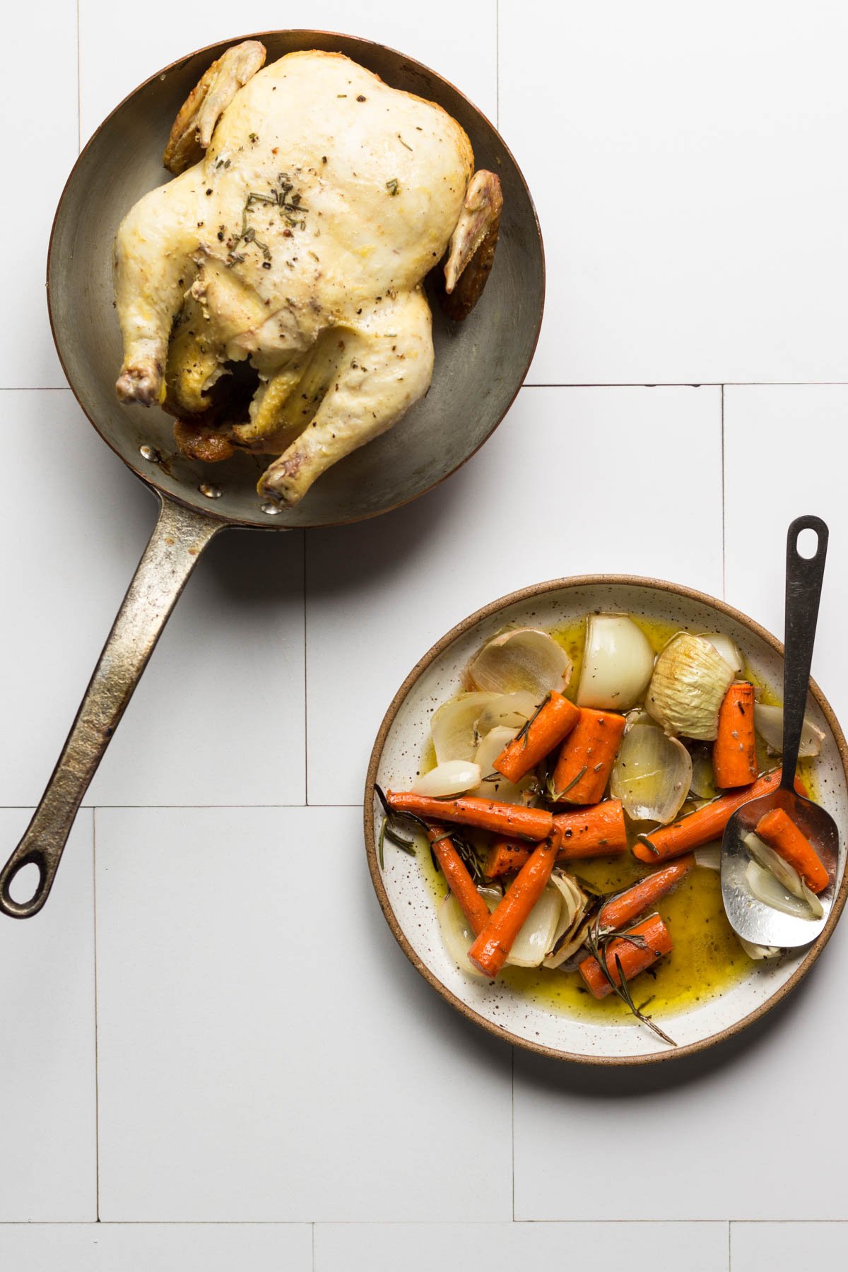 Vegetables on a plate and chicken in a saute pan