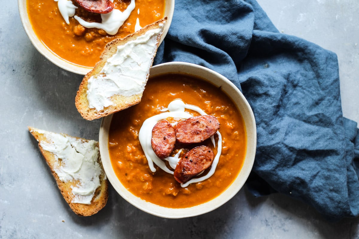 Thai Squash soup in a bowl with bread