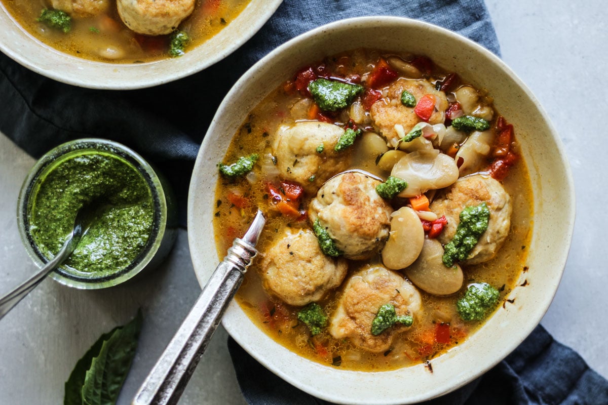 chicken meatball soup with pesto in a bowl