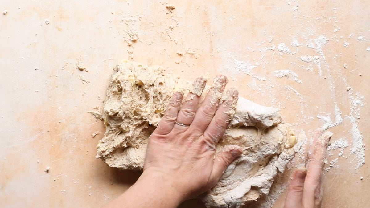 Folding biscuit dough with hands for flaky layers