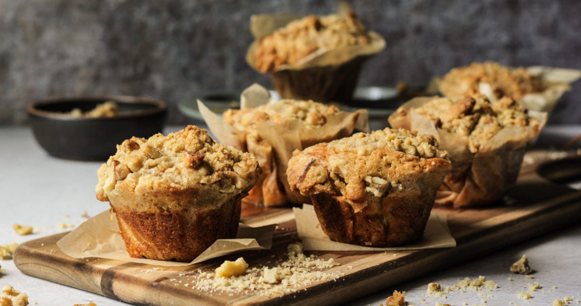 banana walnut muffins on a wooden cutting board
