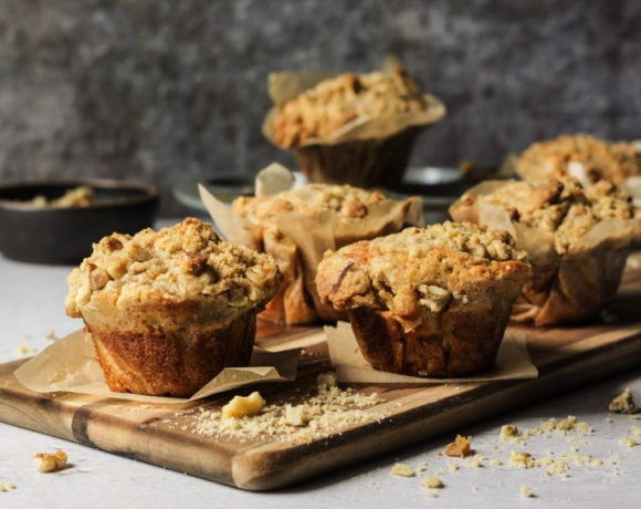 banana walnut muffins on a wooden cutting board
