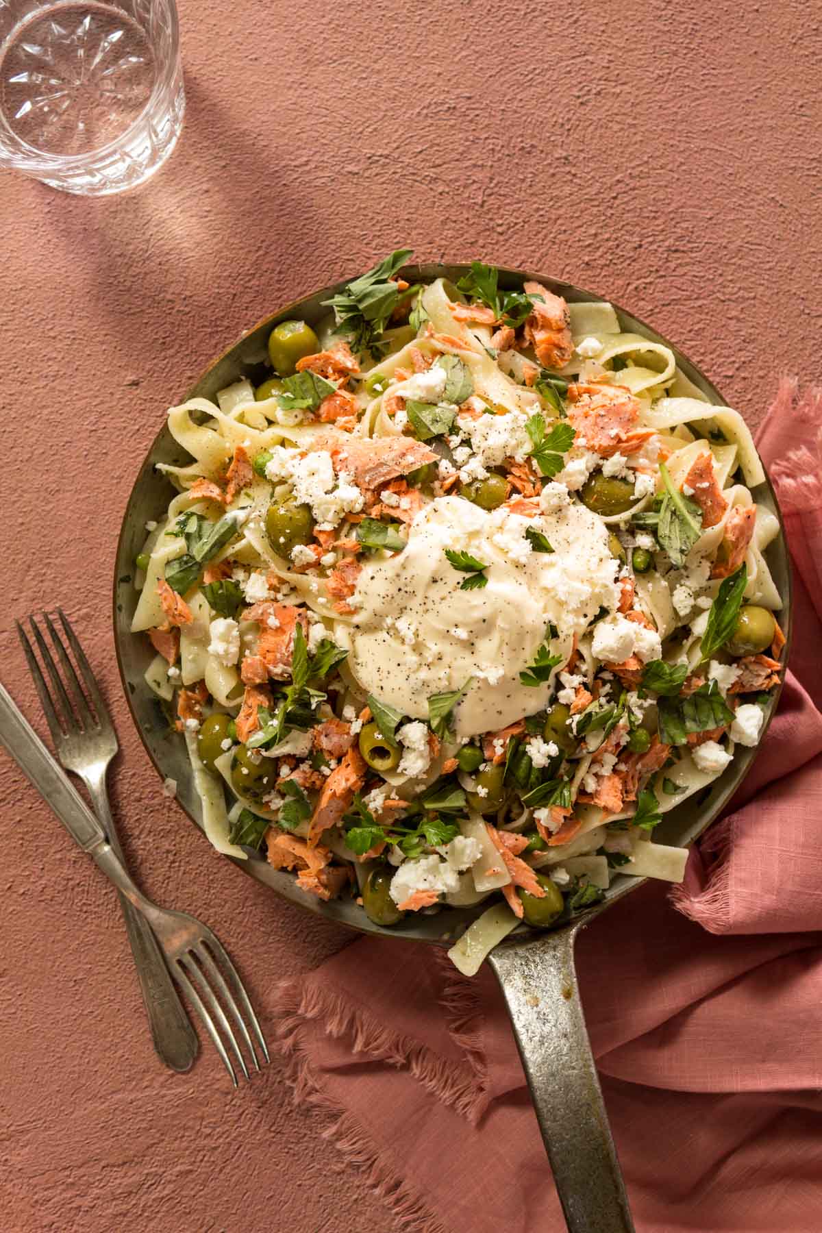 Salmon pasta with creme fraiche in a skillet with forks