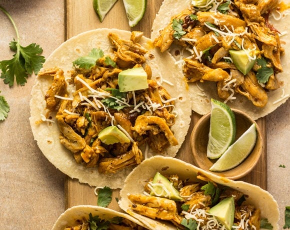 Chipotle orange tacos on a cutting board with limes