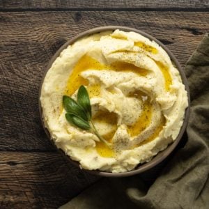 Créme fraîche mashed potatoes in a bowl with melted butter