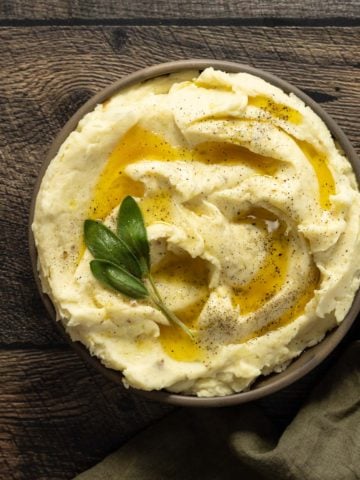 Créme fraîche mashed potatoes in a bowl with melted butter