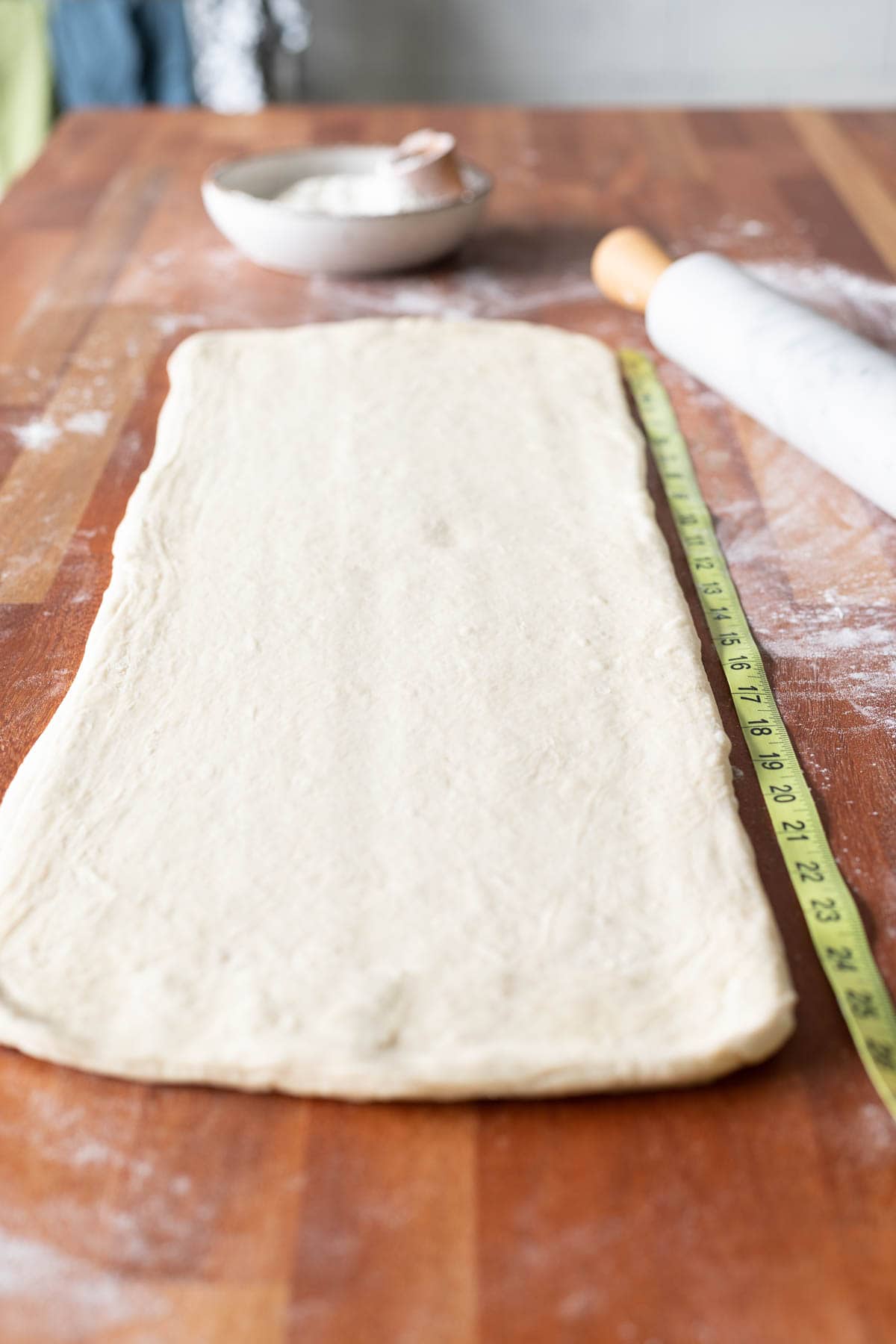 Croissant dough rolled out with measuring tape