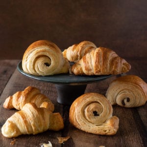 A black plate of French Croissants