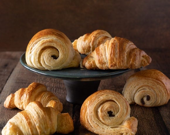 A black plate of French Croissants