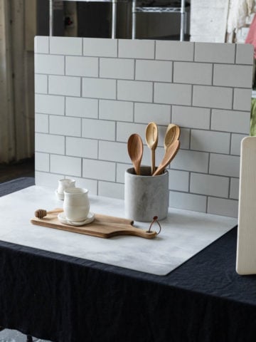 Photography backdrops standing up with a kitchen canister and wooden spoons