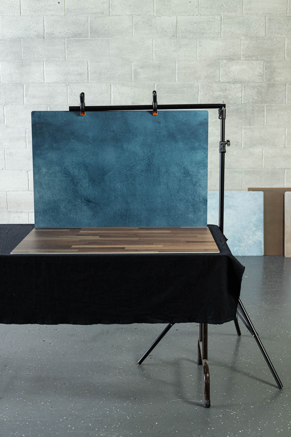 A photography stand hanging up a backdrop