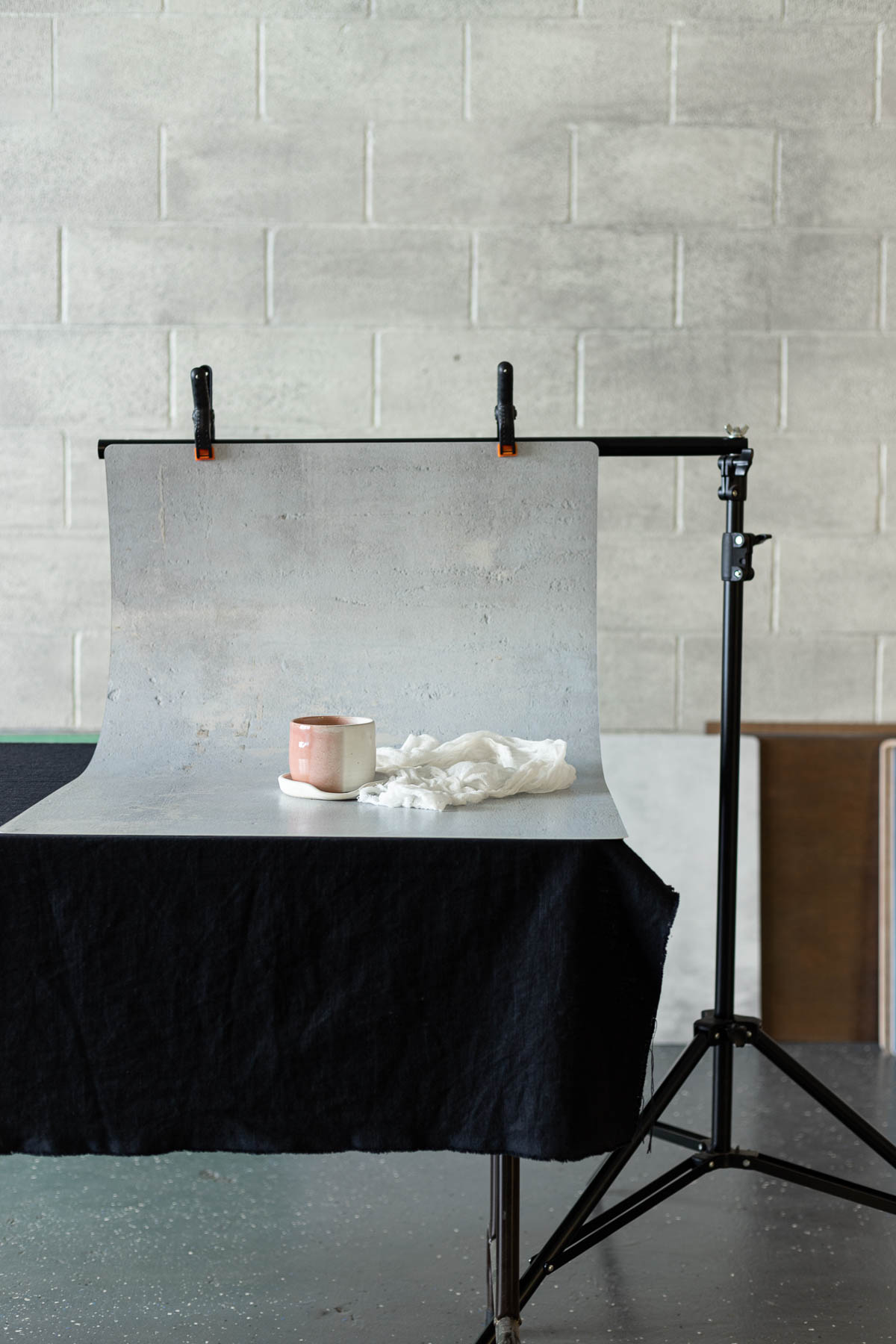 backdrop with a pink cup held up with a photo stand