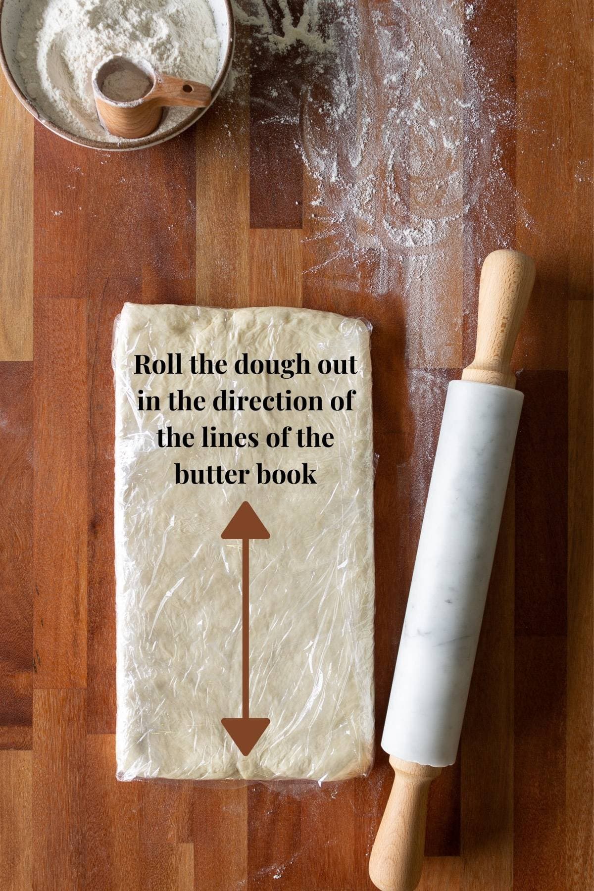 Croissant dough with a rolling pin