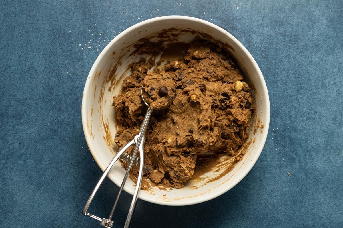 Double chocolate chip cookie dough in a bowl with an ice cream scoop