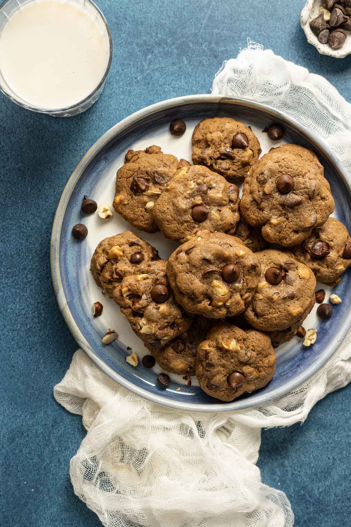 A plate of double chocolate chip cookies with milk