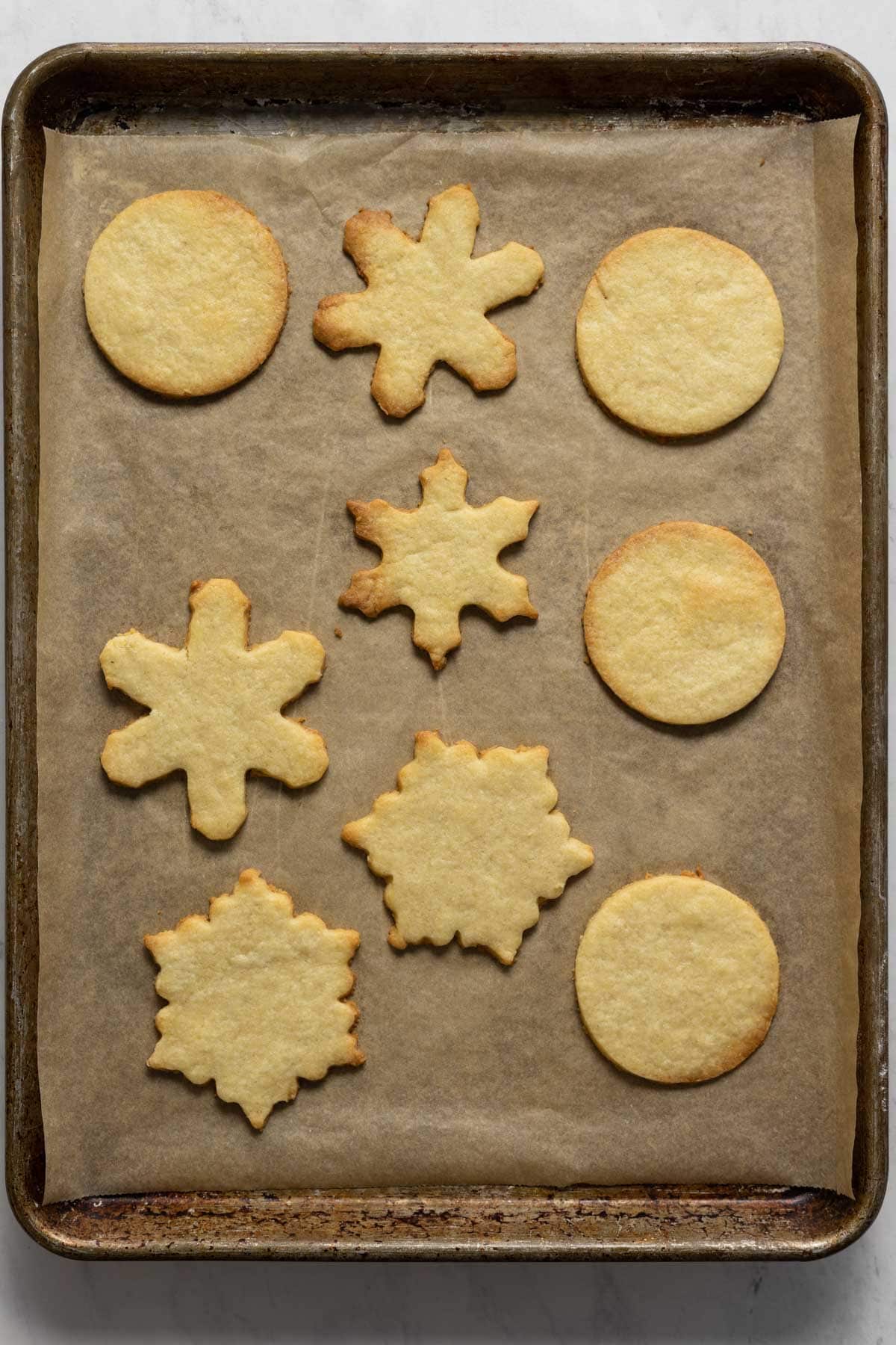 Baked almond shortbread cookies on a sheet pan