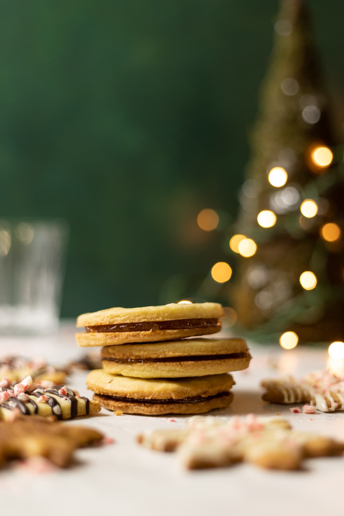 Almond shortbread cookies stacked with christmas lights 