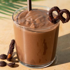 Close up of Chocolate Peanut Butter Pretzel smoothie on a yellow background