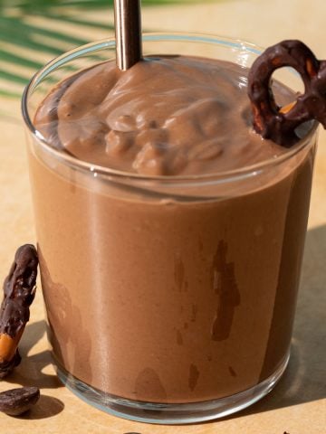 Close up of Chocolate Peanut Butter Pretzel smoothie on a yellow background