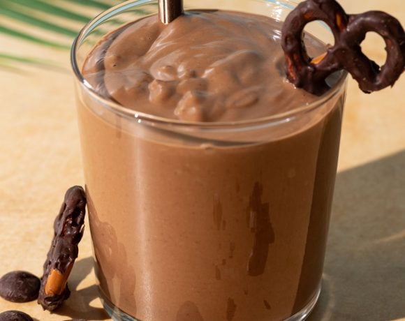 Close up of Chocolate Peanut Butter Pretzel smoothie on a yellow background