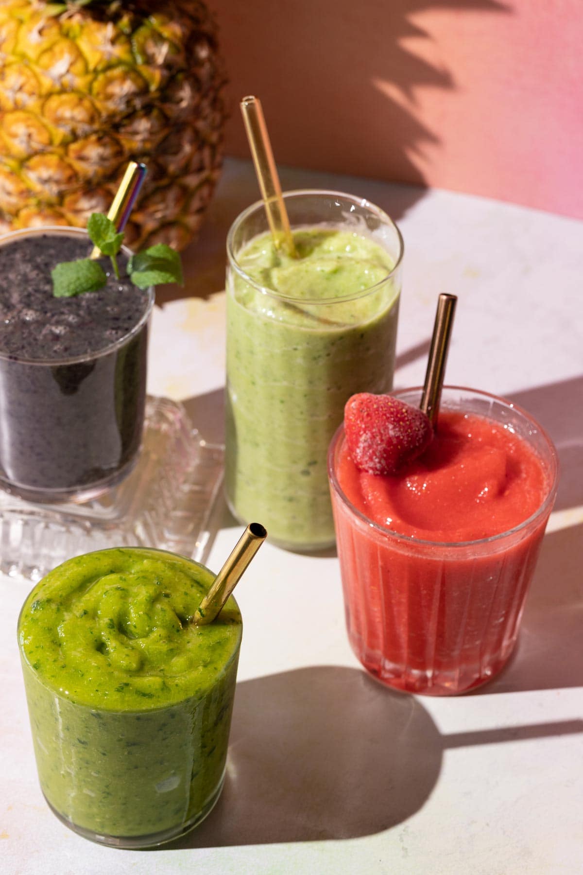 Fruit smoothies in glasses with a pineapple