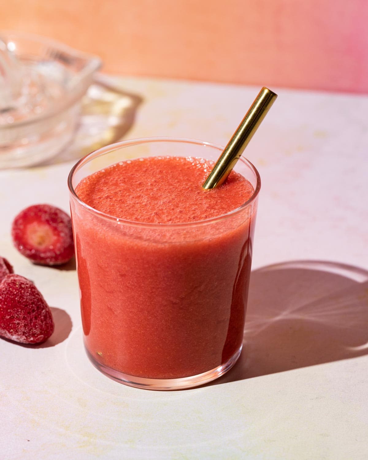 Close up of Strawberry Lemonade smoothie with strawberries on a colorful background